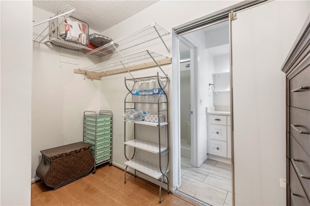 walk in closet featuring light wood-style floors