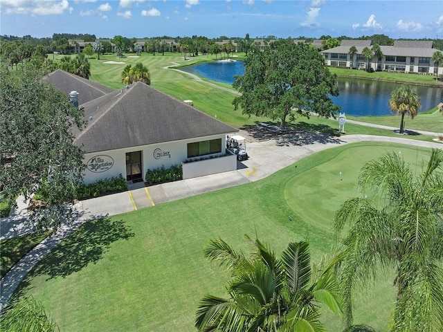 drone / aerial view featuring view of golf course and a water view