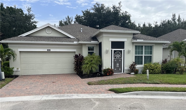 view of front of house featuring a garage and a front lawn