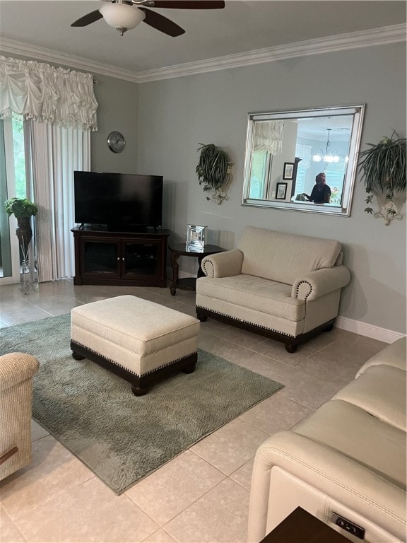 living room featuring tile patterned flooring, ceiling fan with notable chandelier, and ornamental molding