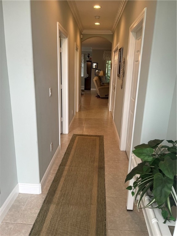 hallway featuring crown molding and light tile patterned floors