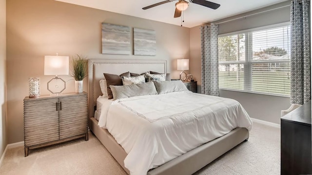 bedroom featuring ceiling fan and light colored carpet