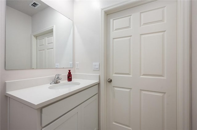 bathroom with vanity and visible vents