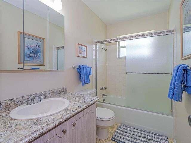 2800 Indian River Blvd Unit 10R, Vero Beach, FL 32960 - bathroom featuring toilet, combined bath / shower with glass door, and vanity
