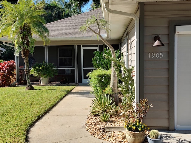 doorway to property with a yard