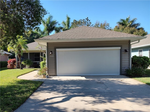 ranch-style home with a garage and a front lawn