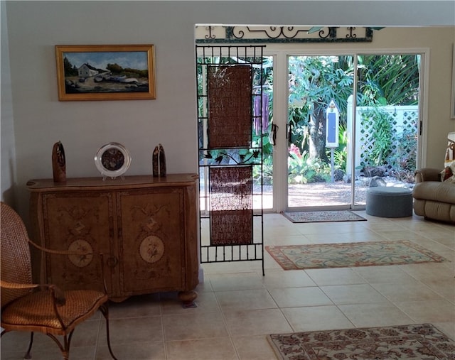 entryway with a wealth of natural light and light tile patterned floors