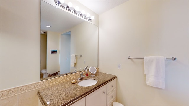 bathroom with vanity and toilet