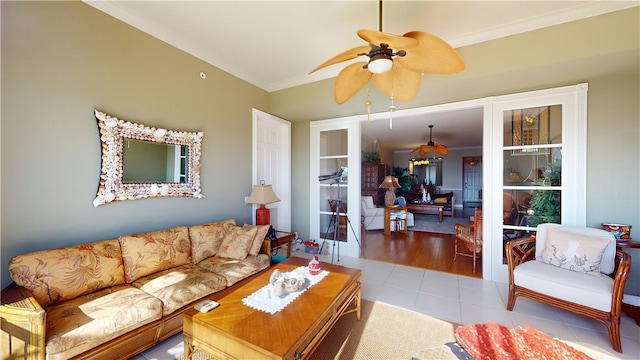 living room with light hardwood / wood-style flooring, ceiling fan, and crown molding