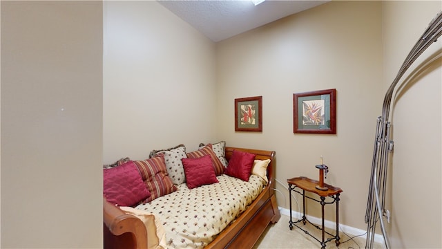 carpeted bedroom featuring a textured ceiling and vaulted ceiling