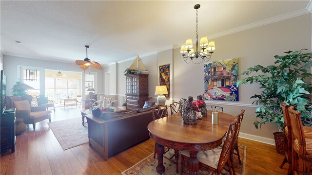 dining room with dark hardwood / wood-style flooring, a chandelier, and crown molding