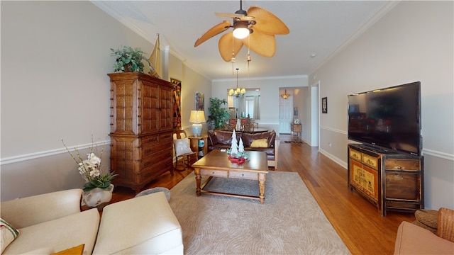 living room featuring ornamental molding, wood-type flooring, and ceiling fan