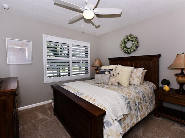 bedroom featuring ceiling fan and dark colored carpet