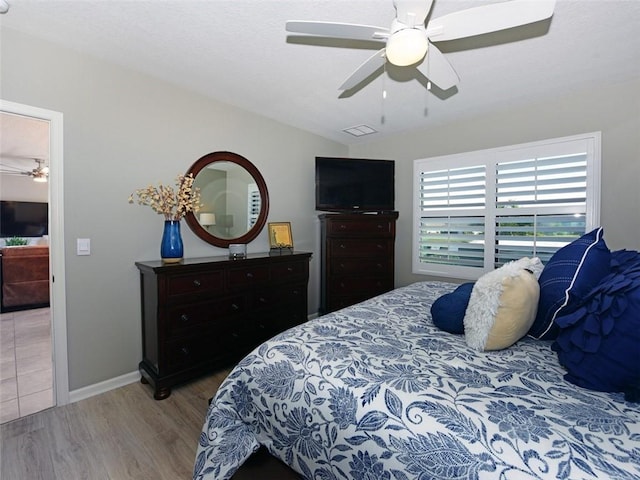 bedroom featuring ceiling fan and hardwood / wood-style flooring