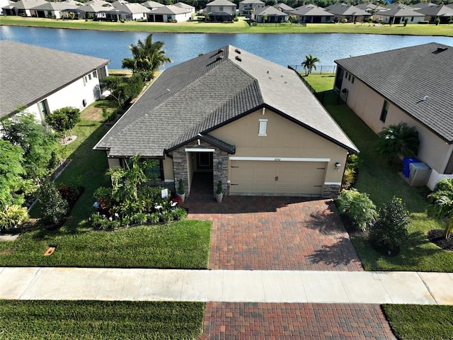 birds eye view of property with a water view