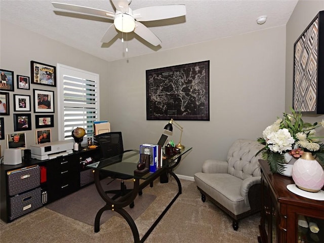 carpeted home office with ceiling fan