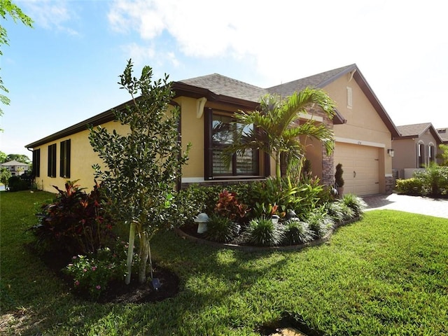 view of home's exterior featuring a garage and a yard