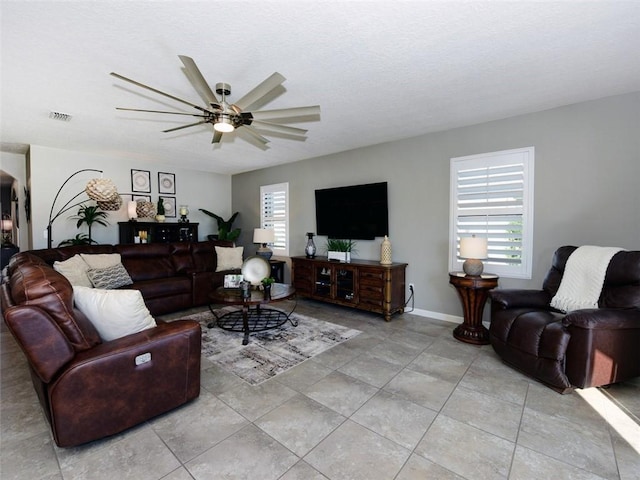 tiled living room with ceiling fan