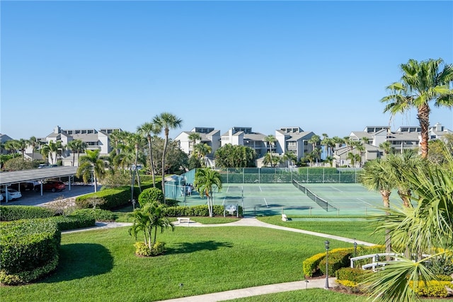 view of sport court with a lawn