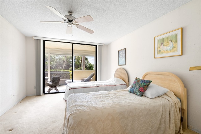 carpeted bedroom with access to exterior, ceiling fan, and a textured ceiling