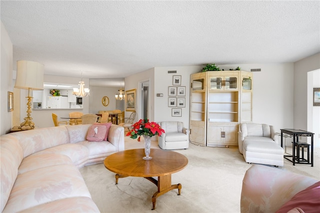 living room with light carpet, a textured ceiling, and a notable chandelier