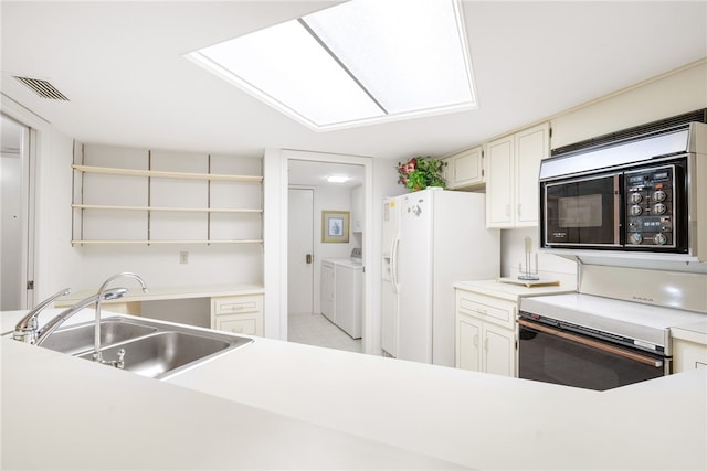 kitchen with sink, washing machine and dryer, white refrigerator with ice dispenser, and electric stove