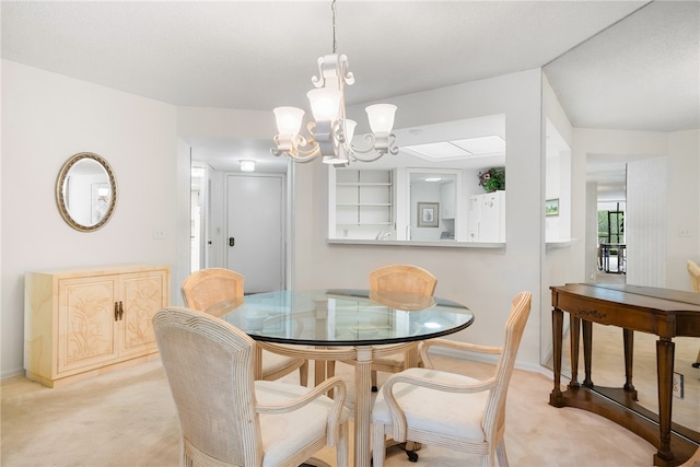 dining room featuring a chandelier and light colored carpet