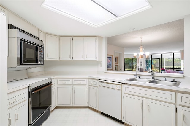 kitchen with sink, black appliances, white cabinets, a chandelier, and hanging light fixtures