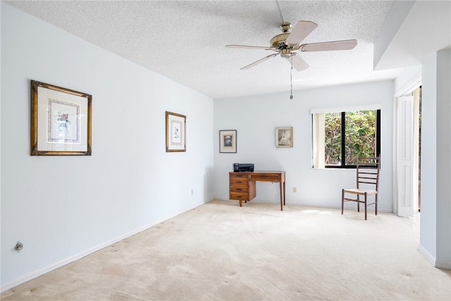 interior space with a textured ceiling and ceiling fan