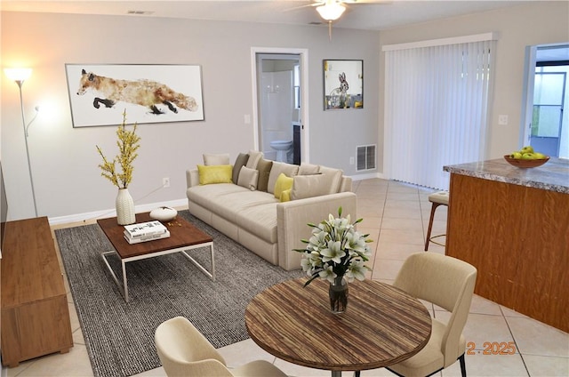 living room with light tile patterned flooring and ceiling fan