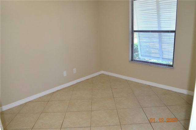 unfurnished room with light tile patterned floors