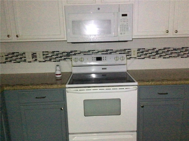 kitchen featuring white cabinetry, white appliances, and tasteful backsplash