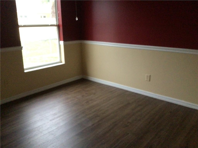 spare room with dark hardwood / wood-style flooring