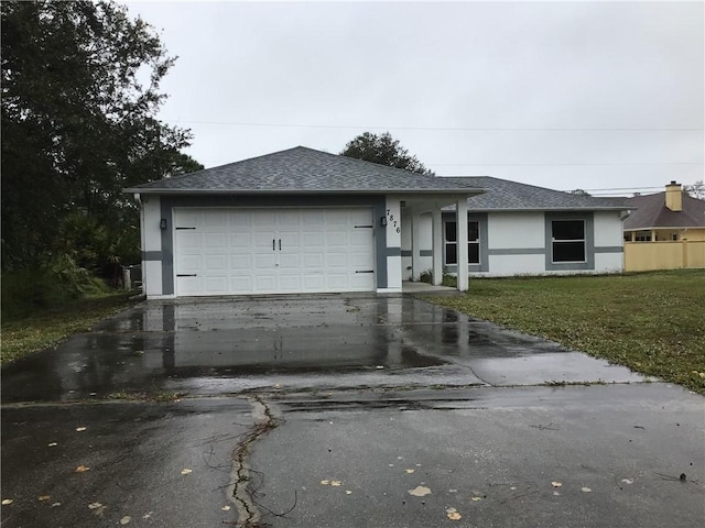 ranch-style home with a garage and a front lawn