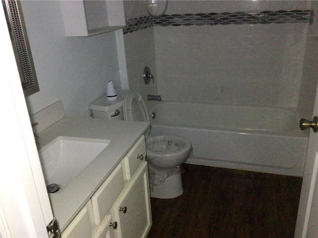 full bathroom with vanity, hardwood / wood-style floors, tiled shower / bath combo, and toilet