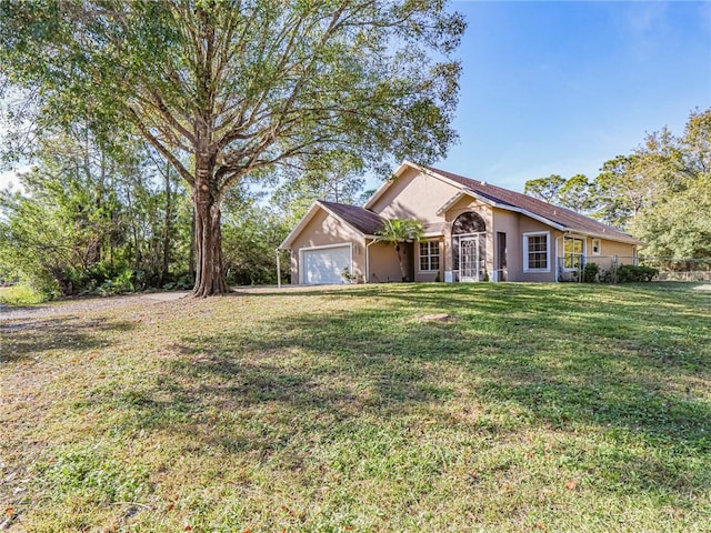 ranch-style house featuring a garage and a front yard