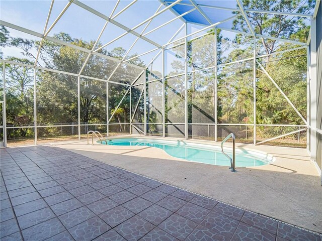 view of pool featuring a lanai and a patio