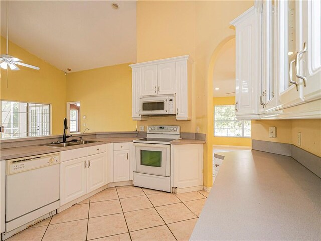 kitchen featuring ceiling fan, sink, light tile patterned floors, white appliances, and white cabinets