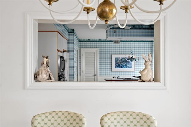 kitchen with wall oven and a chandelier