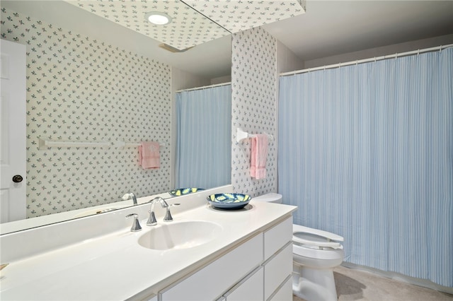 bathroom featuring vanity, a shower with shower curtain, and toilet