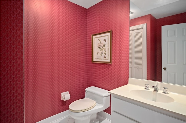 bathroom with vanity, toilet, and tile patterned flooring