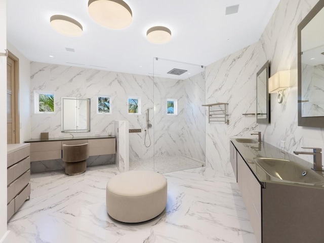 bathroom with vanity, tile walls, and walk in shower