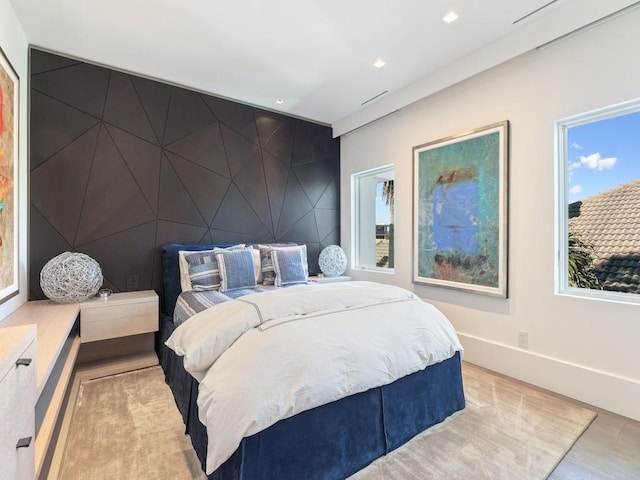 bedroom featuring light wood-type flooring and multiple windows