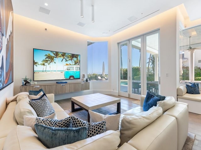 living room with light hardwood / wood-style flooring and french doors