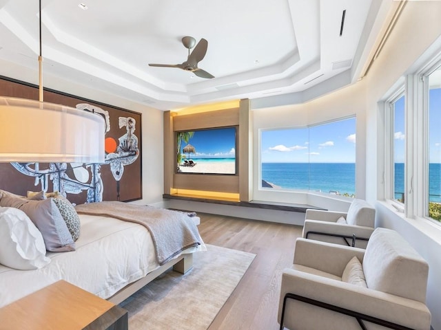 111 Mariner Beach Ln, Vero Beach, FL 32963 - bedroom featuring a raised ceiling, wood finished floors, and ceiling fan