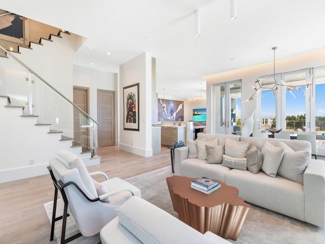 living room with light hardwood / wood-style flooring and a chandelier