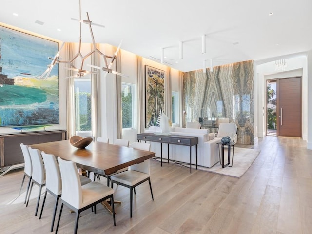 111 Mariner Beach Ln, Vero Beach, FL 32963 - dining room with a chandelier and light wood-style floors