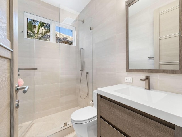 bathroom with walk in shower, vanity, tile walls, and toilet