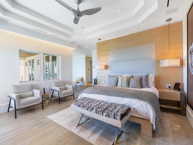 111 Mariner Beach Ln, Vero Beach, FL 32963 - bedroom featuring a tray ceiling, light wood finished floors, recessed lighting, and a ceiling fan