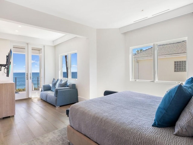 bedroom featuring hardwood / wood-style floors and access to outside